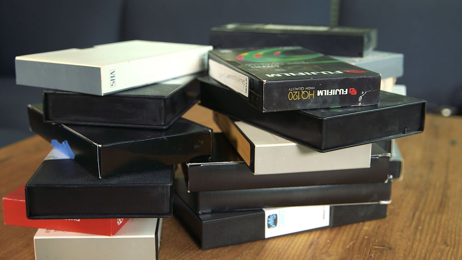 Two stacks of vhs video tapes in cases.